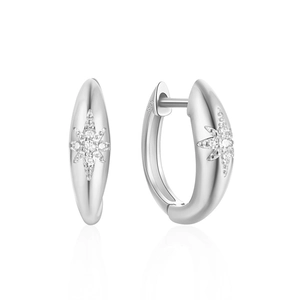 Macro detail of 925 sterling silver hoop earrings with star pattern and zircon inlay