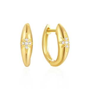 Macro detail of gold-plated 925 sterling silver starburst hoop earrings with cubic zirconia