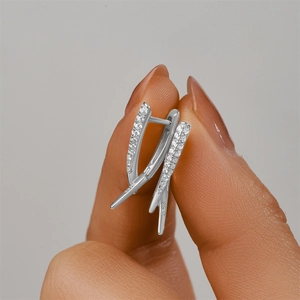 Close-up of S925 sterling silver hoop earrings with X-shape crisscross and pavé zircons
