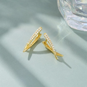 Macro detail showing S925 hallmark on gold plated sterling silver crossover earrings