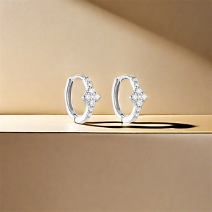 Close-up of S925 sterling silver hoop earrings featuring a sparkling diamond flower design