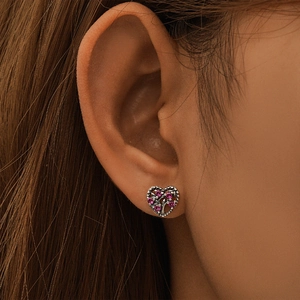 Detailed close-up of S925 sterling silver heart earring with pink crystal tree inlay