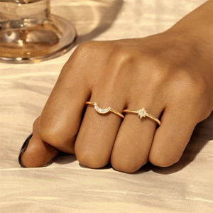 Detail of s925 silver gold rings featuring pavé zircon moon and star designs on satin