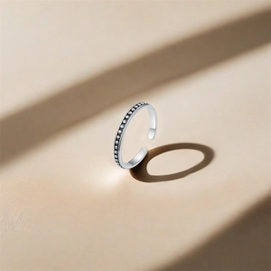 Detail of S925 sterling silver ring featuring a retro beaded dot texture and open design