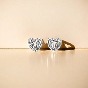 Close-up of S925 sterling silver heart earrings with figure silhouettes and zircon inlay