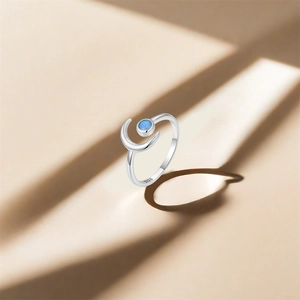 Detail of S925 sterling silver ring featuring a crescent moon and blue opal stone