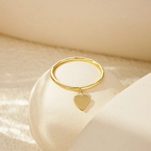Macro view of S925 sterling silver hammered gold ring with polished heart pendant detail