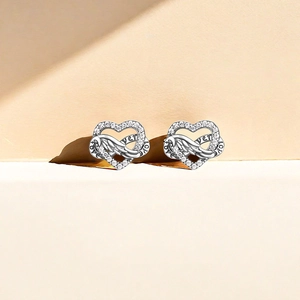 Detail of heart stud earrings with angel wings, pavé cubic zirconia and Love Forever text