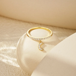 Detailed view of s925 silver gold ring with sparkling moon pendant and zircon stones