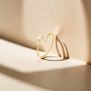 Detailed shot of S925 sterling silver stamp on golden ring with white opal stones