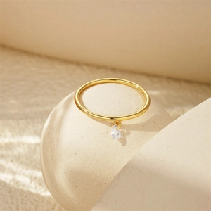 Close-up of a gold s925 silver ring featuring a teardrop-shaped zircon moon pendant