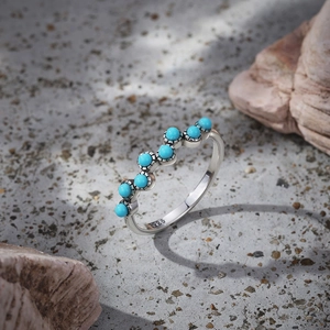 Macro shot of S925 silver ring featuring turquoise stones and vintage lotus engraving
