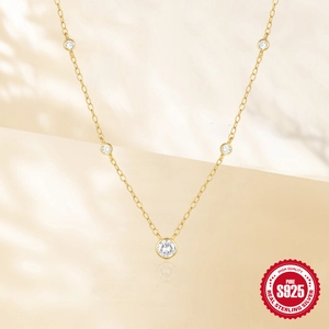 Classic S925 sterling silver gold necklace featuring five bezel-set sparkling cubic zirconia