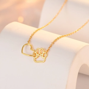 Detail shot of gold S925 sterling silver necklace with heart and cat paw pendant