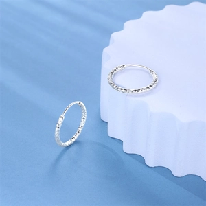 Detail view of S925 sterling silver hoop earrings with diamond-cut textured patterns