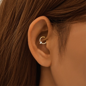Close-up of gold S925 silver daith piercing ring with marquise and round diamonds