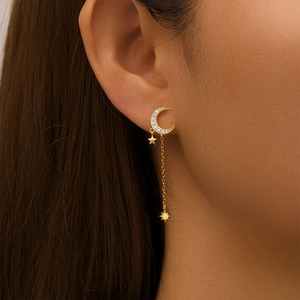 Detail of gold-plated star and moon drop earring with sparkling micro-pave zircons