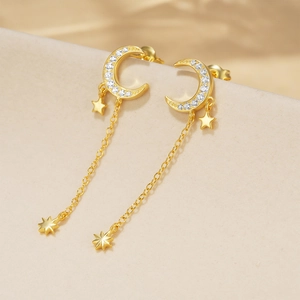 Macro view of gold S925 silver moon and star tassel earrings with zircon pave
