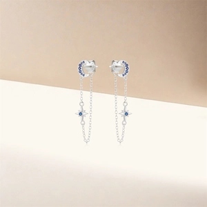 Macro shot of S925 sterling silver moon and star tassel earring with blue stones