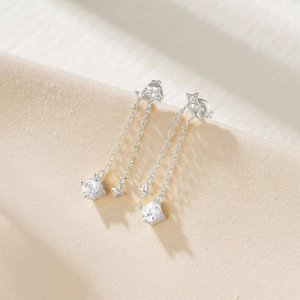 Macro detail of S925 sterling silver tassel earrings with star motifs and sparkling cubic zirconia