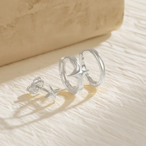 Detail view of S925 sterling silver star earrings showing the authentic material stamp