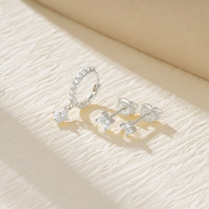 Macro shot of S925 sterling silver four-leaf clover earrings with sparkling zircon