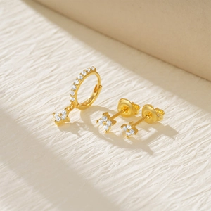 Detailed macro view of S925 sterling silver four-leaf flower earrings with CZ inlay