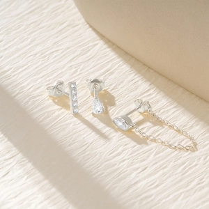 Detailed view of silver S925 stud earring set with zircons and chain link detail