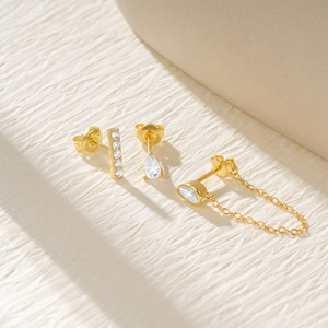 Detailed view of three-piece gold plated earring set with zircon star and drop shapes
