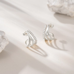 Macro view of S925 sterling silver triple-layered hoop earrings with inlaid zircon crystals