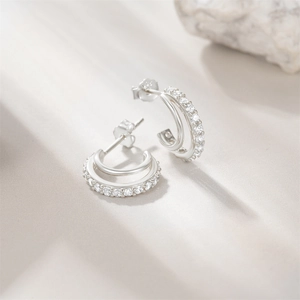 Detailed view of S925 sterling silver C-shaped earrings with paved cubic zirconia stones