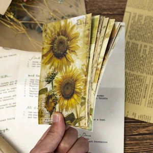Close-up of vintage sunflower junk journal papers with retro postmark and floral textures