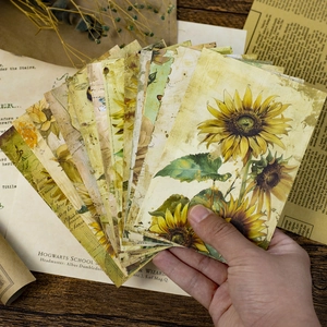Close-up of vintage sunflower aesthetic paper cards held in hand for scrapbooking