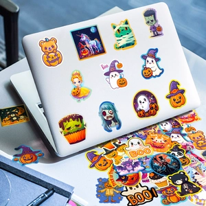 Detailed Halloween stickers collection on a laptop featuring ghosts and pumpkins