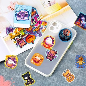 Detail of Halloween stickers with pumpkin and ghost patterns on a smartphone case