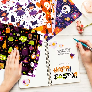 Flat lay of Halloween scrapbook paper featuring cute ghosts, witches and skeletons