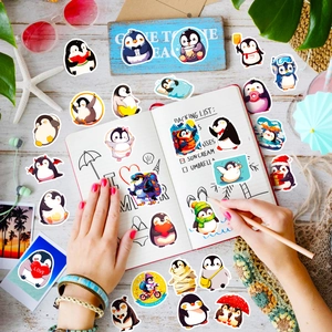 Detailed view of various cute cartoon penguin stickers on a notebook and wooden desk