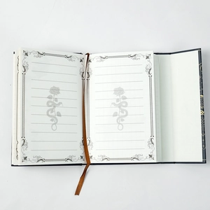 Macro view of vintage owl notebook with gold constellation patterns and lined inner pages