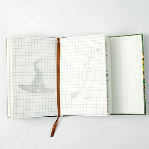 Detail view of the vintage wizard themed notebook with grid pages and velvet bookmark