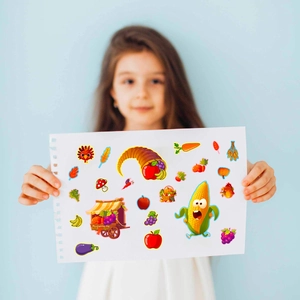 Detail of a child holding Thanksgiving puzzle stickers with turkey and pumpkin designs