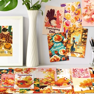 Close-up of Thanksgiving postcards featuring turkeys and pumpkins on a white desktop