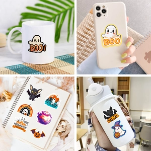Waterproof Halloween stickers shown on a mug, phone case, notebook, and water bottle