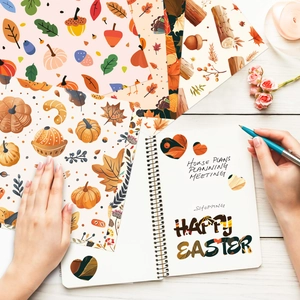 Close-up of Thanksgiving scrapbooking paper with pumpkin and turkey patterns on wood