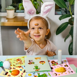 Child holding Thanksgiving DIY puzzle stickers with turkey and pumpkin motifs