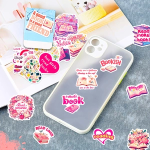 Detailed view of pink bookish stickers with creative floral designs on laptop background