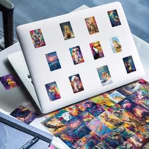 Artistic vibrant animal stickers featuring colorful wolf, tiger and fox designs on a laptop