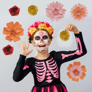 Child Day of the Dead costume with pink skeleton print and multi-color paper flower decor