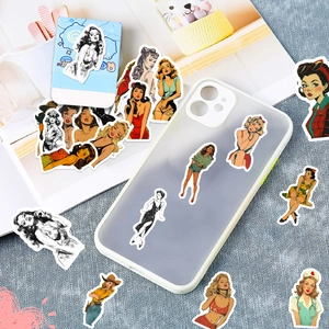 Detail of vintage pin-up girl aesthetic stickers on a phone case and packaging