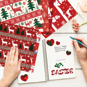 Christmas scrapbook paper featuring reindeer and snowmen on a white wooden background