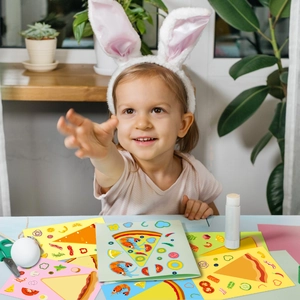 Girl creating DIY cartoon pizza stickers with colorful background cards and glue stick